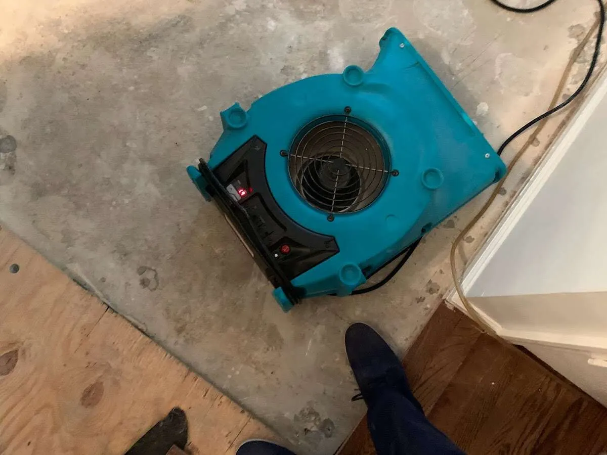Air mover drying subfloor during Commercial Water Damage Restoration in Delafield